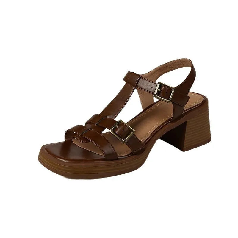 Women's black retro platform sandals with a T-shaped buckle strap and chunky heel.