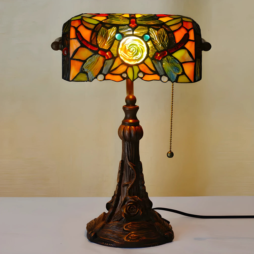 Tiffany table lamp with stained glass shade on wooden desk, 36cm tall with warm lighting