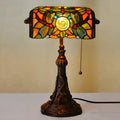 Tiffany table lamp with stained glass shade on wooden desk, 36cm tall with warm lighting