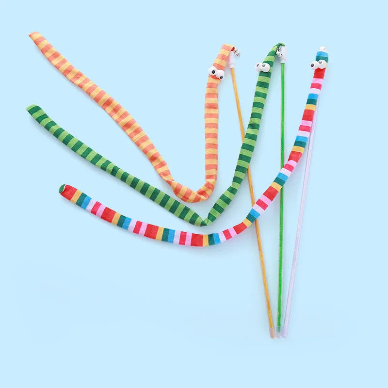 A colourful cat teaser wand with a long plush strip and a bell, held by a person.