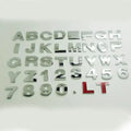 Metal zinc alloy car bumper sticker showing 2.5cm English letter on black background