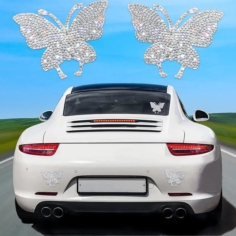 Glass car sticker with diamond detailing in butterfly or bear claw design, 7cm by 6cm.