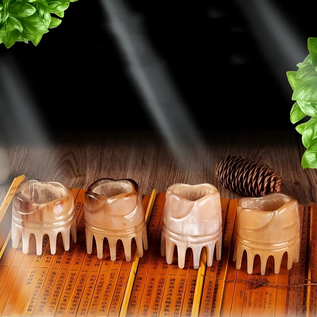 White buffalo horn comb with wide teeth on one side and pointed tips for head meridian massage.