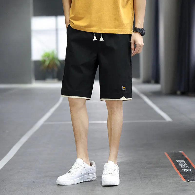 Korean style loose-fit straight-leg casual shorts in green, shown on a model.