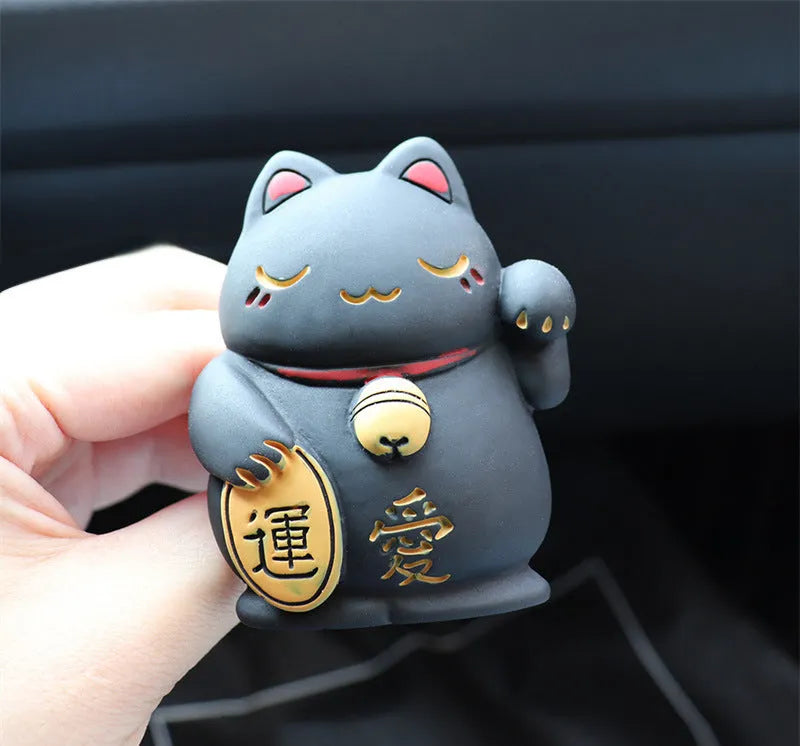 Black cat and white cat resin car vent clip aromatherapy diffuser on a car air conditioning vent.