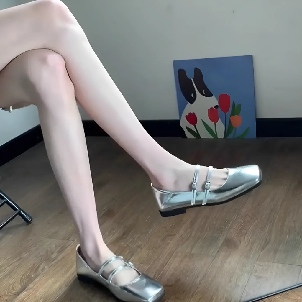 Women's silver genuine leather ballet flats with a cross buckle strap and flat sole.