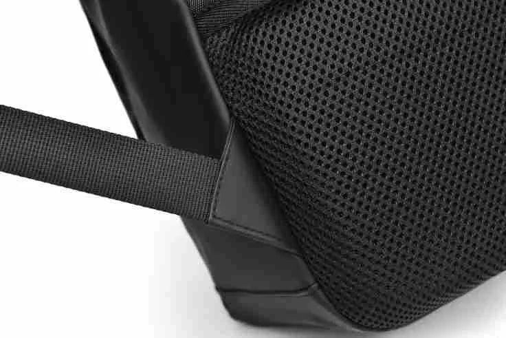 Men's waterproof PU backpack in black with simple sewing thread design and separate computer compartment.