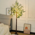 1.8 metre tall artificial olive leaf tree with warm white LED lights illuminated in a garden setting.