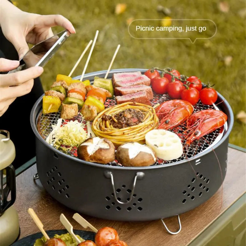 Portable stainless steel barbecue grill with detachable design and storage bag for camping.