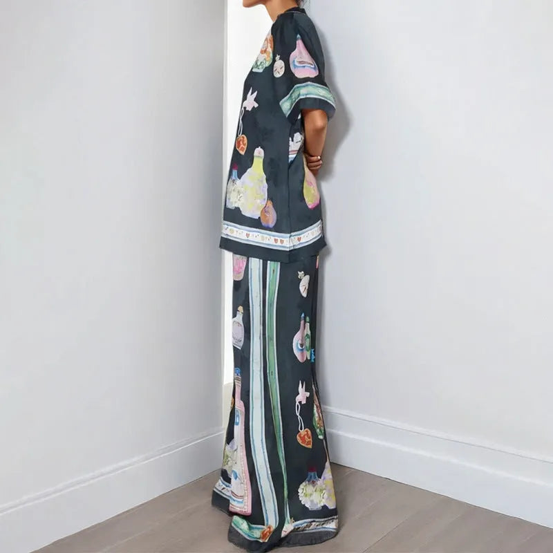 Black women's casual set with cartoon print, featuring sleeveless cardigan and trousers.