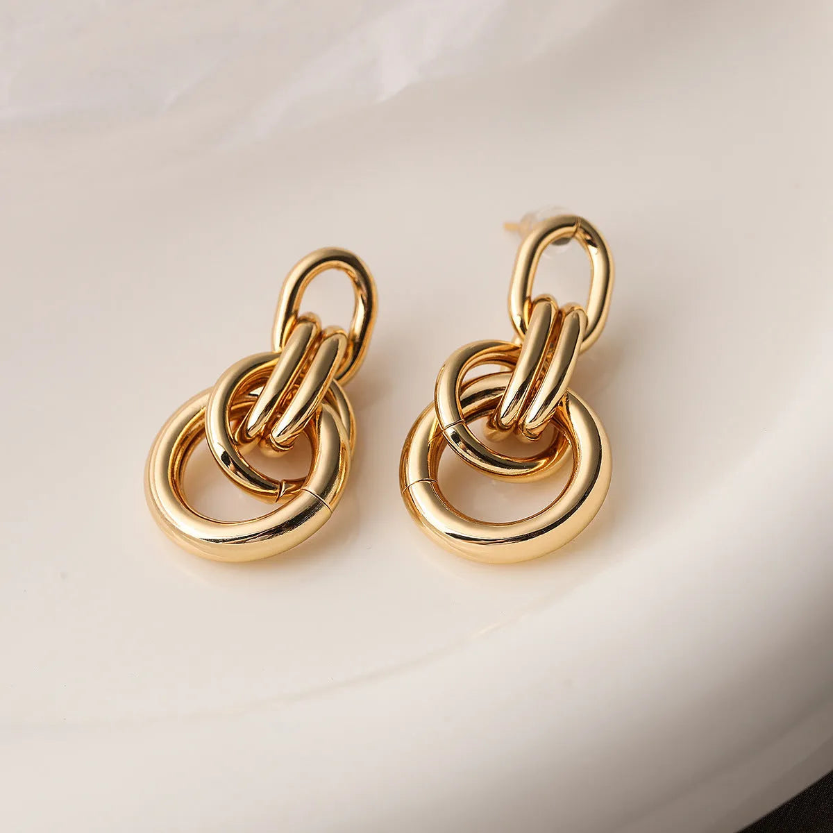 Geometric copper earrings for women in gold with irregular high-profile shape