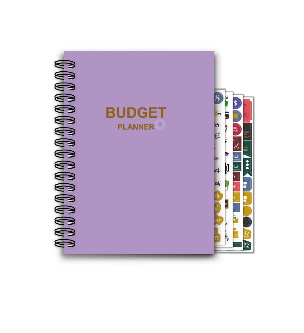 J12 purple coil-bound budget notebook with financial planning stickers and paper clips laid out.