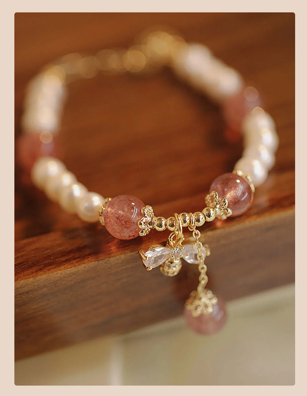 INS style women's crystal bracelet with strawberry quartz stones and a central bow detail.