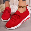 Women's red, black, and blue low-top casual sneakers with a round toe and lace-up front.