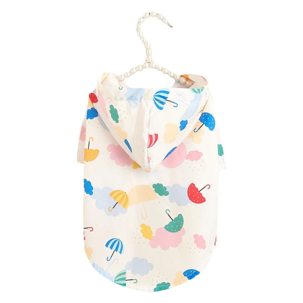 Colourful cartoon umbrella print dog raincoat in polyester fabric on a model dog.
