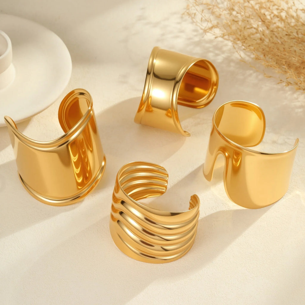 Women's exaggerated wide stainless steel bracelet with 18K gold plating and wave geometric design.
