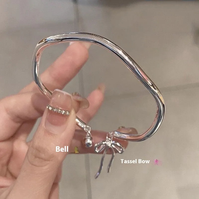 Silver adjustable bow bracelet with bell opening mechanism on zinc alloy chain