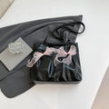 College style black bow tote bag with double shoulder straps showing interior zippered pocket