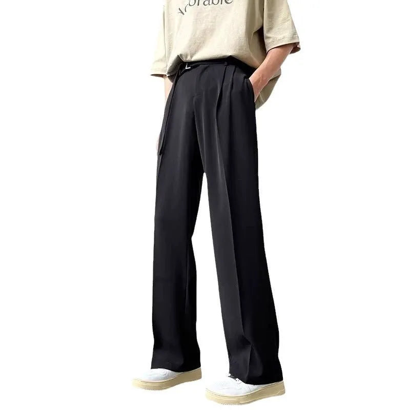 Men's black loose straight-leg trousers with a non-ironing finish on a hanger