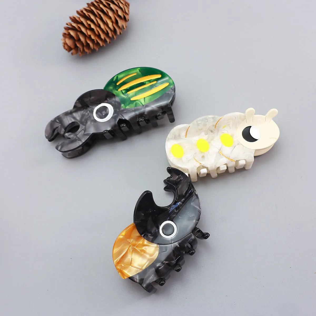 Handmade cellulose acetate insect brooch with beetle grip pin in green, orange, or white caterpillar designs