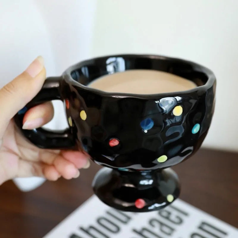 Hand-pinched irregular ceramic mug in a solid colour, showing its unique shape and modern design.