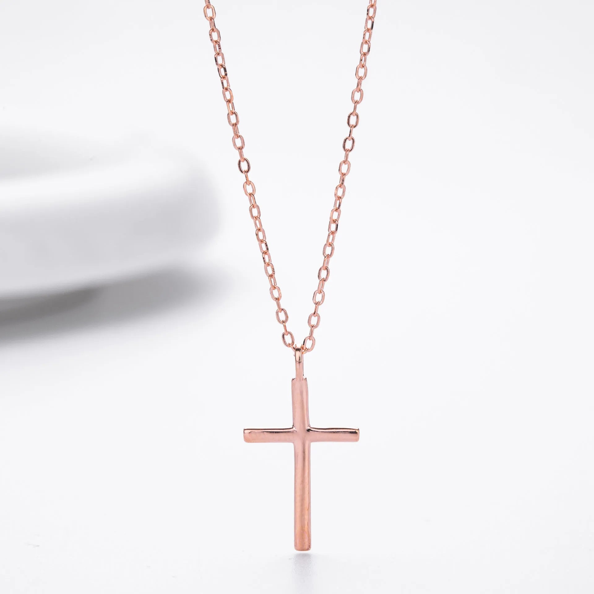 Sterling silver necklace with simple cross pendant on adjustable O-shaped chain in gold, platinum, or rose gold finish