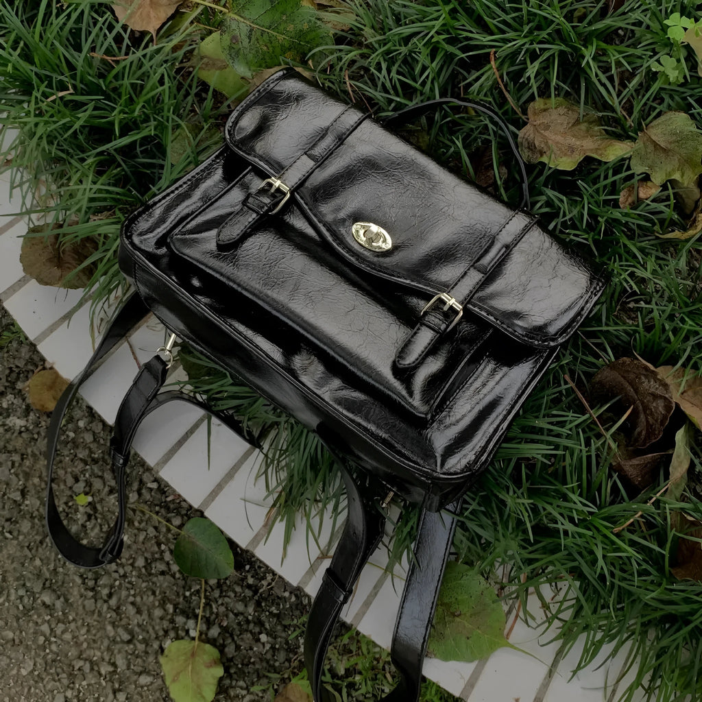 Black college style messenger bag with oil wax leather finish showing front view