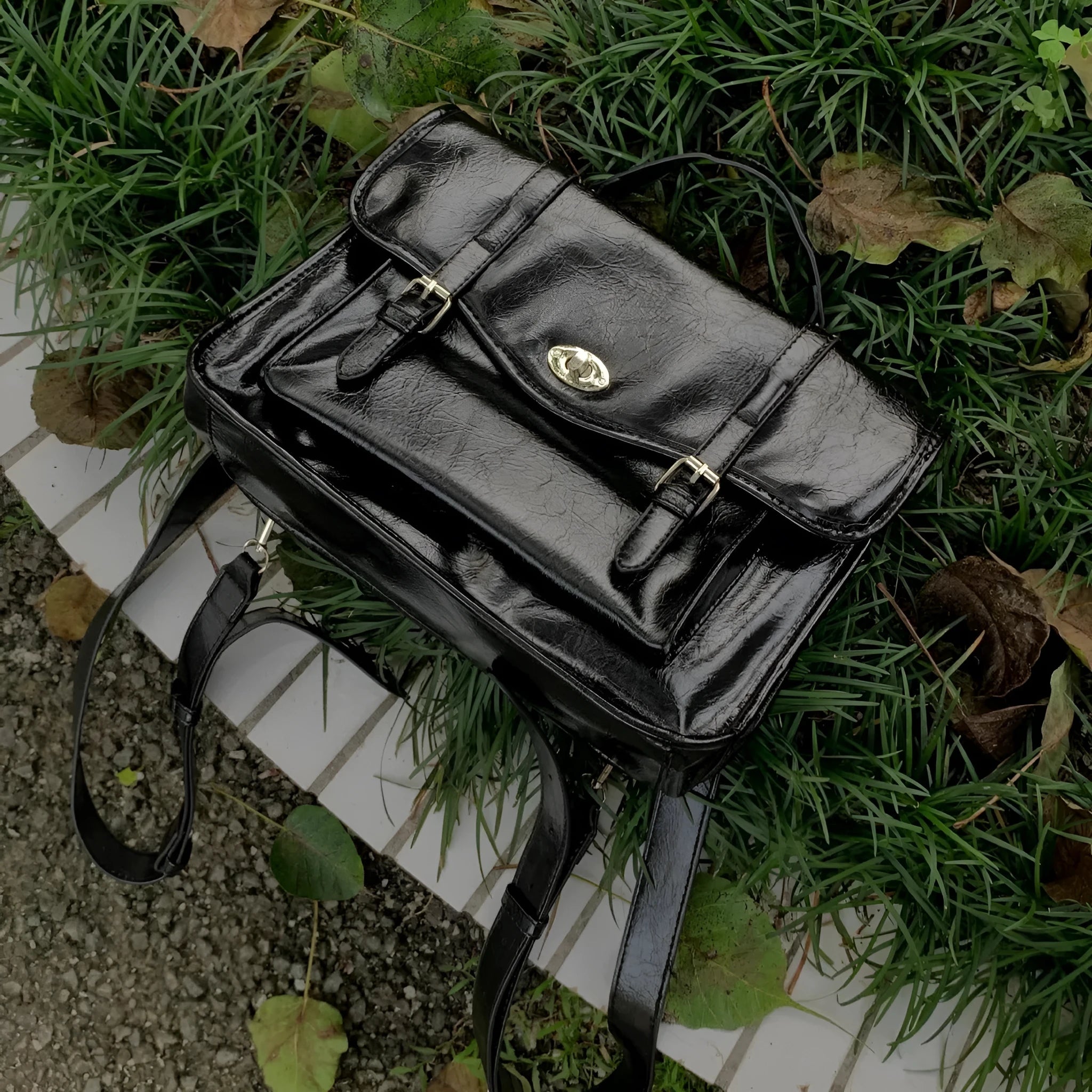 Black college style messenger bag with oil wax leather finish showing front view