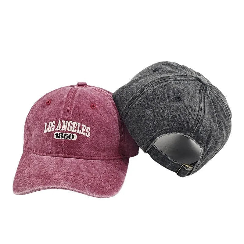 Retro personalised adjustable peaked cap showing distressed letters embroidery on conical crown