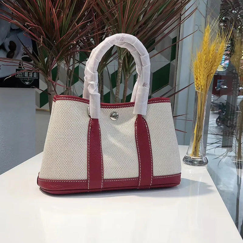 Women's canvas crossbody bucket tote bag with genuine leather trim showing internal organisation pockets