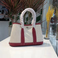Women's canvas crossbody bucket tote bag with genuine leather trim showing internal organisation pockets