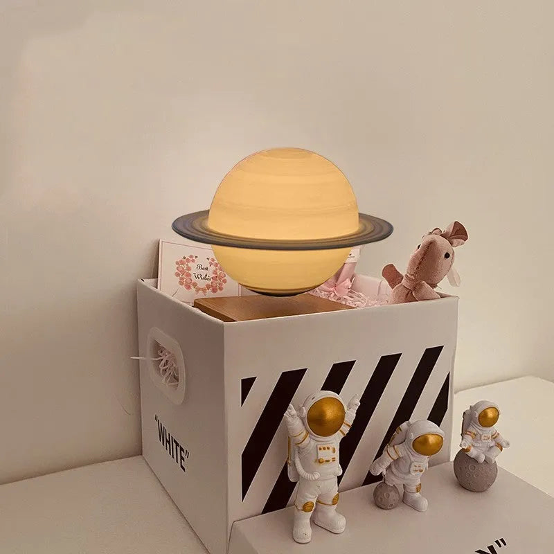 Maglev floating moon planet night light with LED glow and astronaut figures on a table