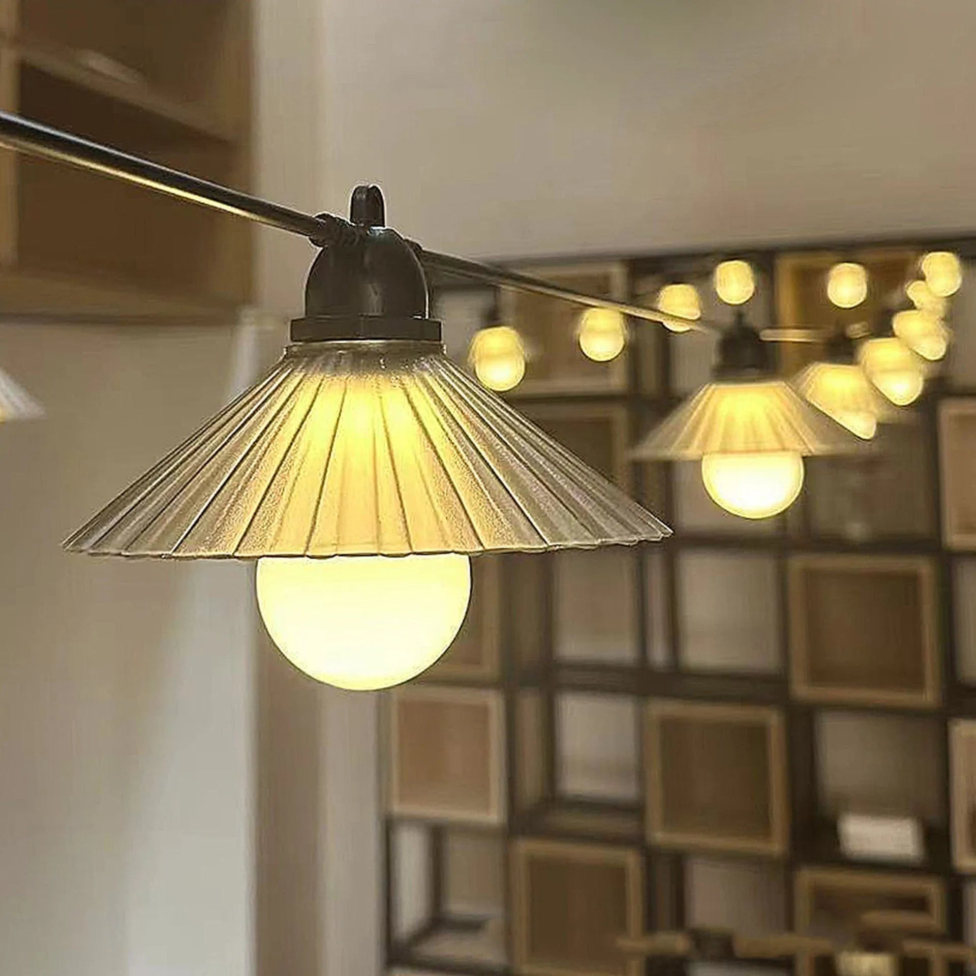 Outdoor LED string lights with flower-shaped bulbs hanging in a garden, showing warm white and coloured options.
