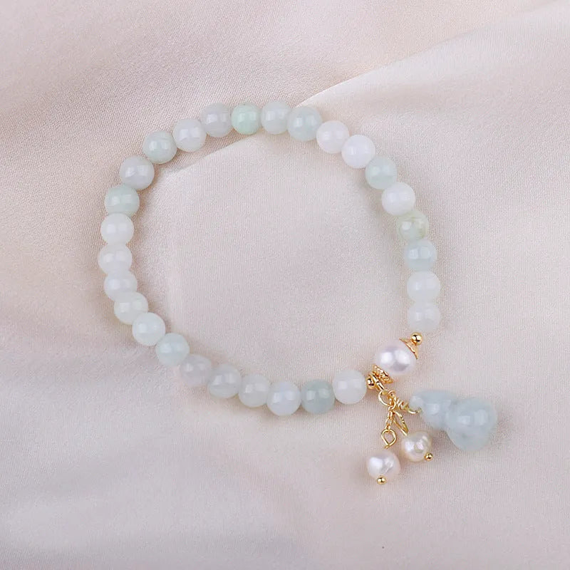 Chinese style jade bracelet with gourd design featuring natural emerald stone and pearl accents