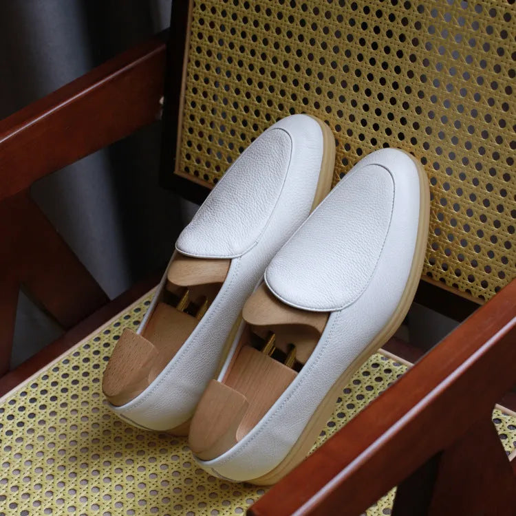 Men's black genuine leather handmade loafers with a flat sole and low-cut ankle design.