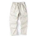 Women's milky white cotton wide-leg trousers with an elasticated waistband on a hanger.