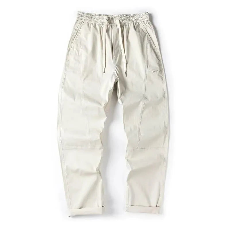 Women's milky white cotton wide-leg trousers with an elasticated waistband on a hanger.