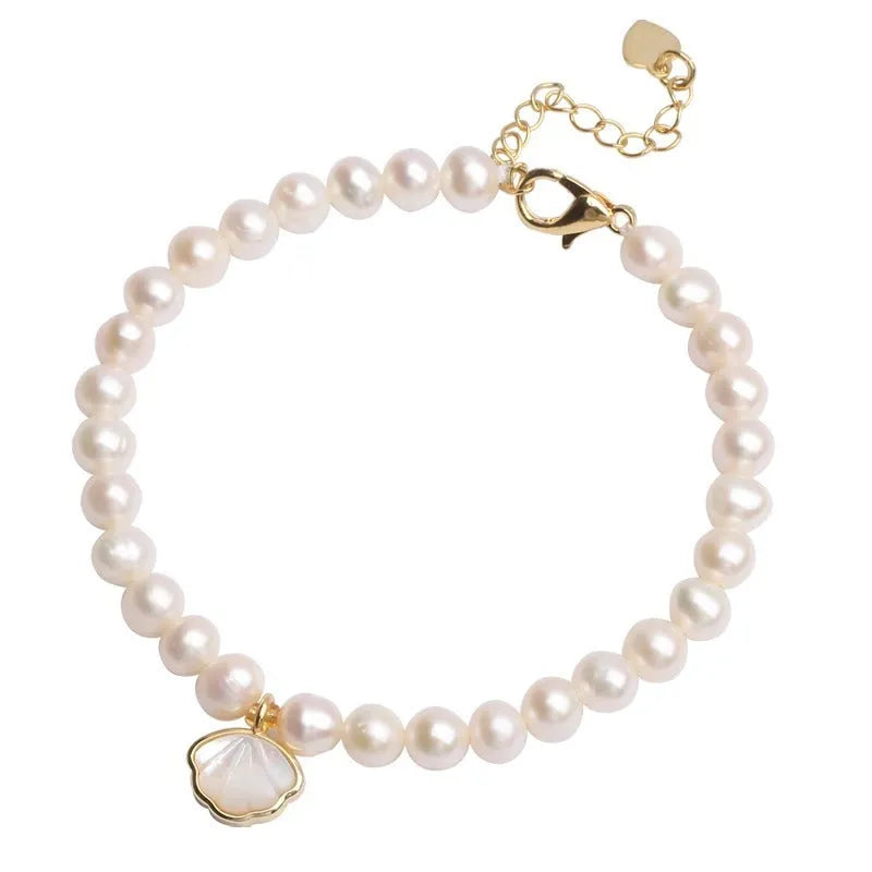 Women's freshwater pearl bracelet with fan-shaped alloy shell and choice of elastic or chain closure