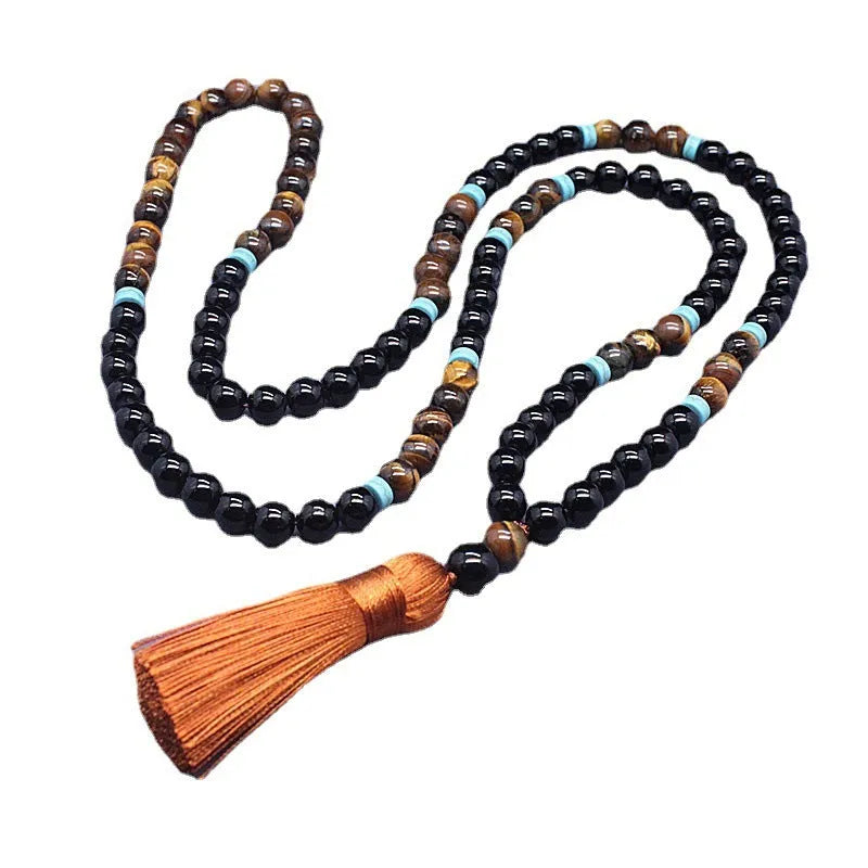 Black agate bracelet and matching tiger's eye geometric necklace set on a plain background.