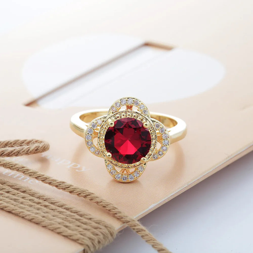 Copper ring with fruit-shaped setting holding a faceted zircon stone.