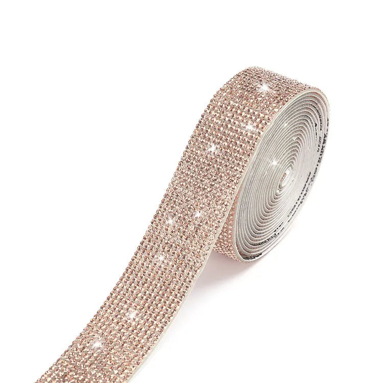 A 1 yard long strip of self-adhesive glass water drills in white and AB colour for clothing decoration