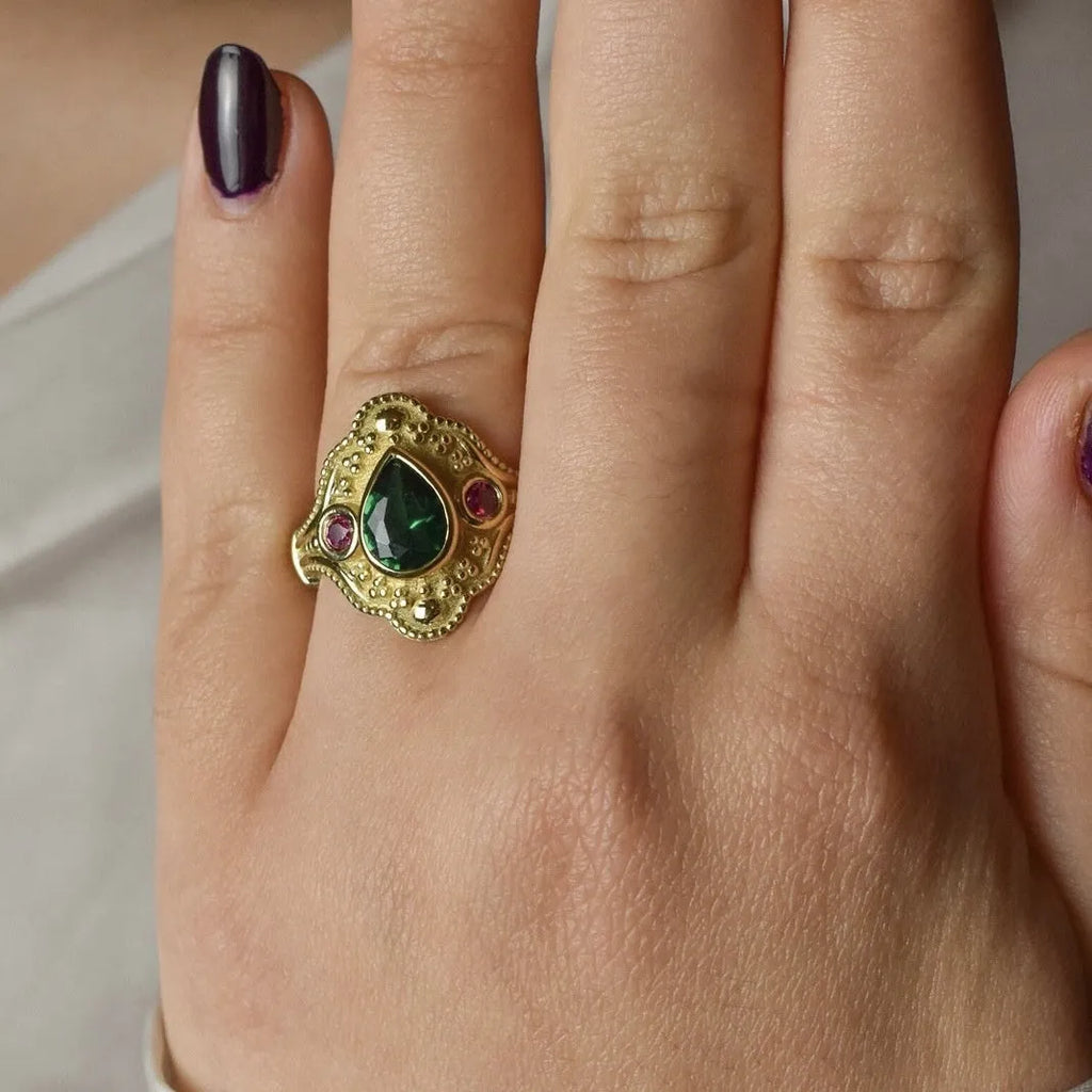 Gold-plated women's ring with geometric design and golden lvzuan colour on a white background.