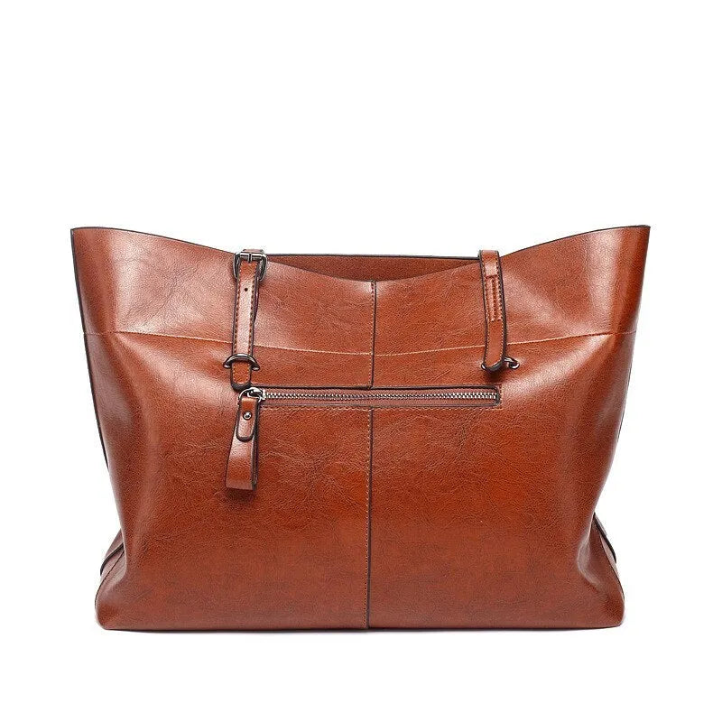 Horizontal waxed cowhide leather cross-body handbag showing two main compartments and phone pocket organisation