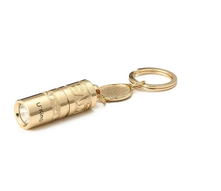 Gold zinc alloy waterproof mini LED flashlight on a keychain.
