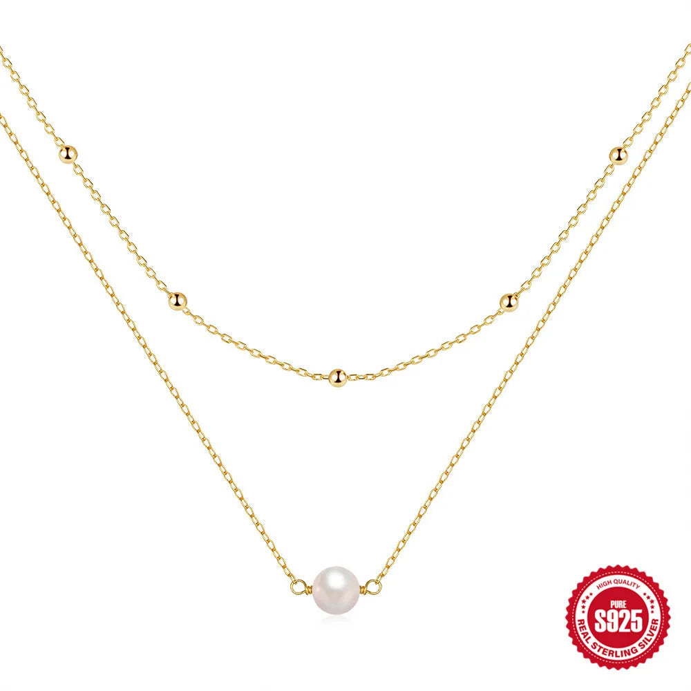 S925 sterling silver double layer necklace with twin diamond-treated pearls and geometric design.