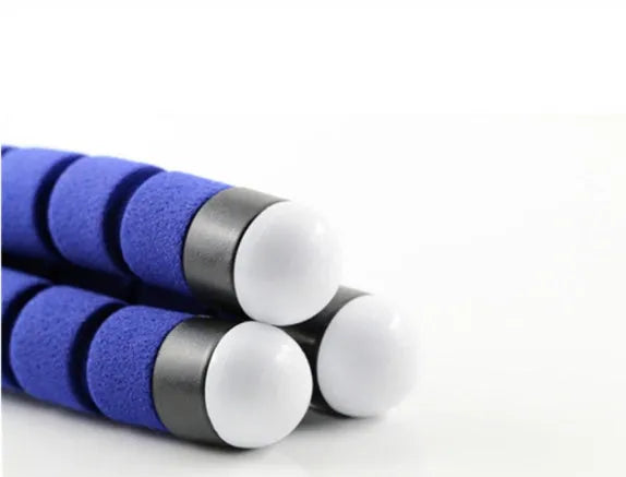 Black flexible octopus-style mini tripod with coiled legs next to a smartphone