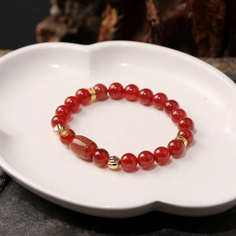 New Chinese style red agate Guanyin bracelet with auspicious patterns on a wrist.