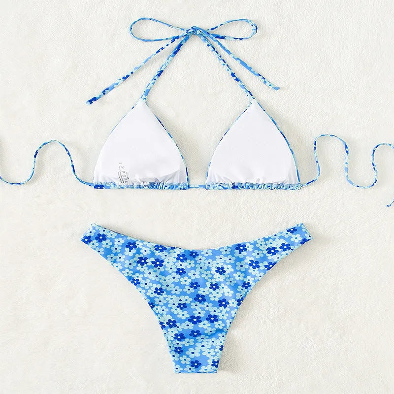 Blue printed women's bikini set with lace-up split top and matching shorts on a neutral background.