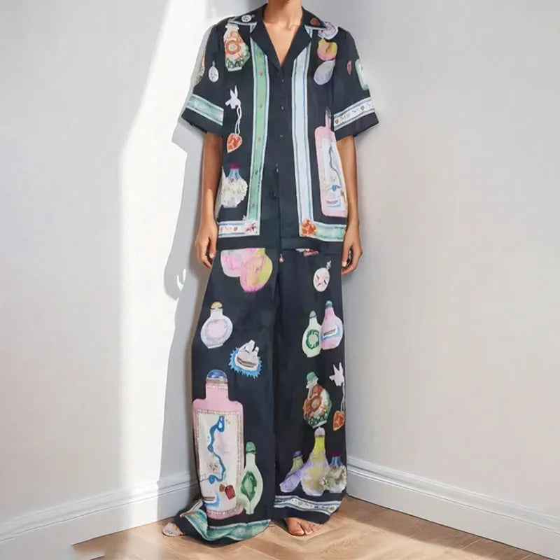 Black women's casual set with cartoon print, featuring sleeveless cardigan and trousers.