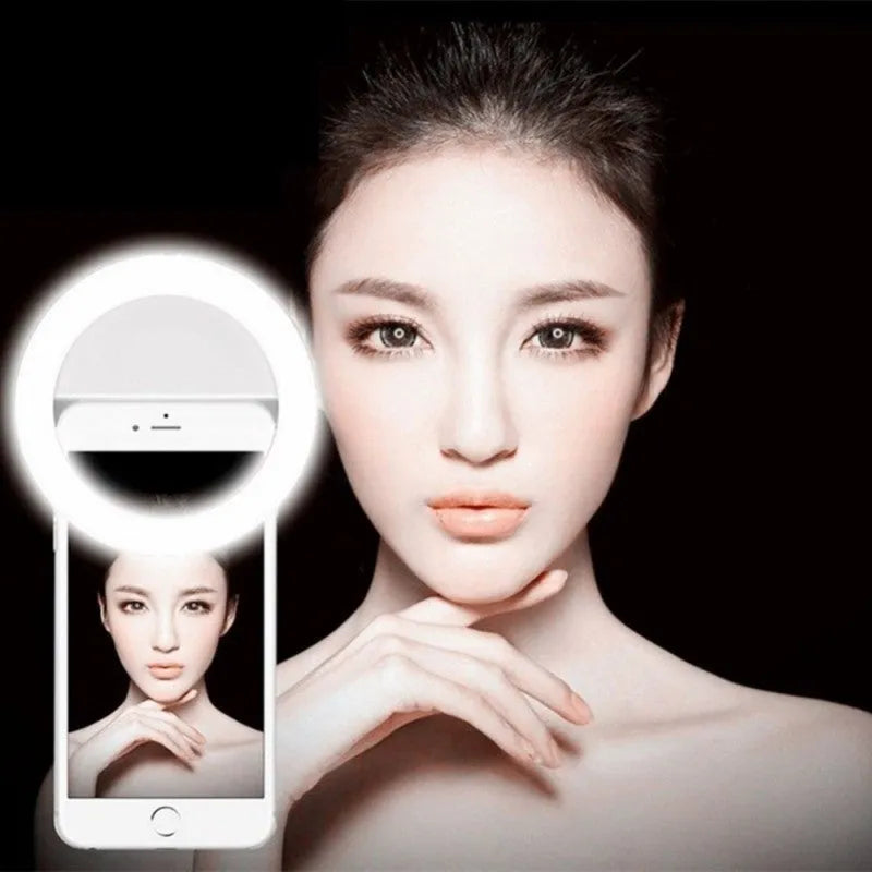 Green clip-on selfie ring light attached to mobile phone showing LED bulbs and anti-slip sponge padding